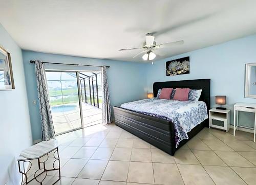 a bedroom with a bed and a ceiling fan at Experience Fun Starts Here w Pool & Wifi in Port Charlotte