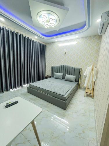a bedroom with a bed in a room with a ceiling at River 6 Hotel in Long Xuyên