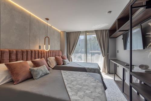 Postel nebo postele na pokoji v ubytování Hotel Glow Medellín