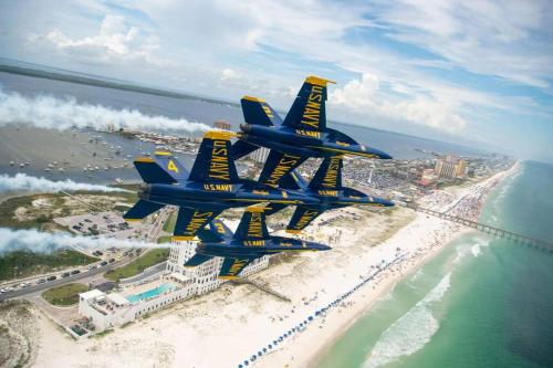 four blue and yellow airplanes flying over a beach at Gulf Breeze Tranquil Retreat 10 min to Beach RV boat jet ski parking in Gulf Breeze