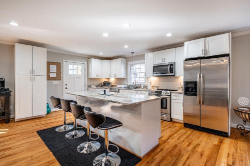 a kitchen with white cabinets and stainless steel appliances at Elegant Gem*Spacious 5BR*King beds*near Duke in Durham