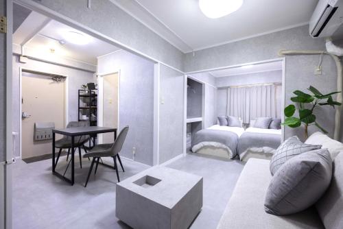 a living room with a bed and a table at 1 line to Asakusa! Modern Room, 5 mins walk from Togoshi-ginza Sta in Tokyo