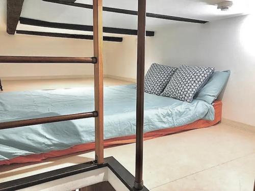 a bunk bed with two pillows on it in a room at Kujo Keshi no Hana in Osaka