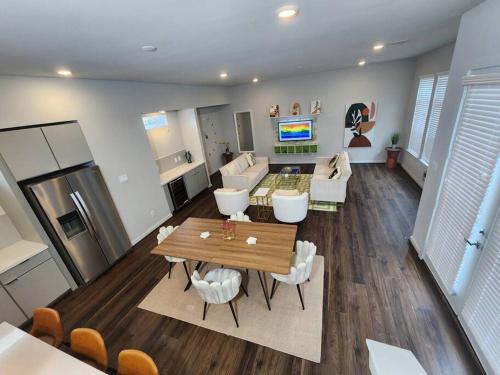 a living room with a table and a kitchen at Galleria Premium 3 Story Home Sleeps 8 in Houston