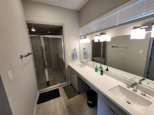 a bathroom with two sinks and a shower at Galleria Premium 3 Story Home Sleeps 8 in Houston