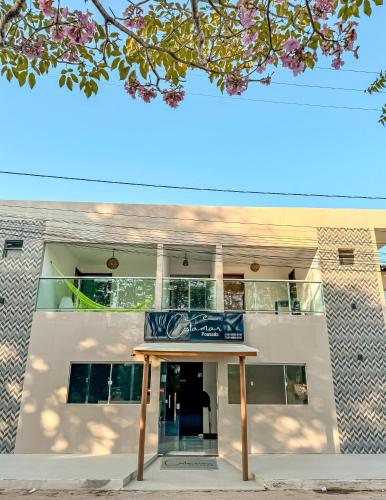 a building with a sign in front of it at Pousada Costamar in Maragogi