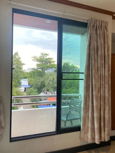 a window with a view of a balcony at New Siam II in Bangkok