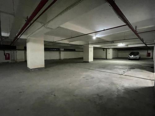 an empty parking garage with a car parked in it at Muong Thanh Grand Quang Tri Hotel in Quang Tri