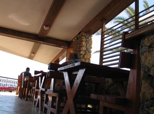 a group of people sitting at a table in a restaurant at Adriatic Apartment in Ulcinj