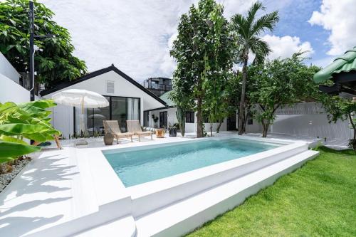 a swimming pool in the backyard of a house at Stunning Pool Villa - In Old Town Chiang Mai Daily Housekeeping in Chiang Mai