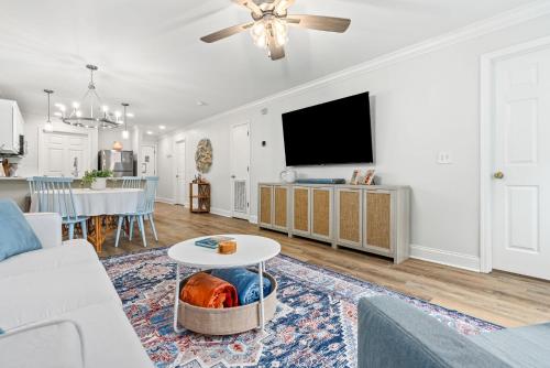 a living room with a couch and a tv at Copper on Ross - Modern and Remodeled in Auburn