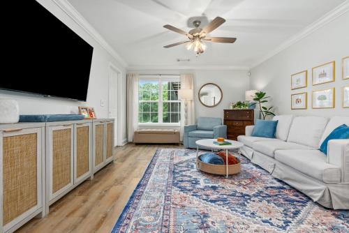 a living room with a couch and a flat screen tv at Copper on Ross - Modern and Remodeled in Auburn