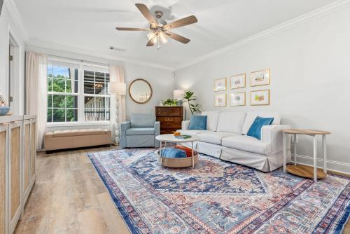 a living room with a couch and a ceiling fan at Copper on Ross - Modern and Remodeled in Auburn