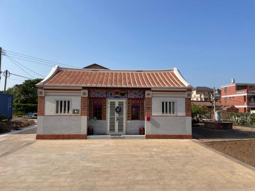 a small building with a tile roof on a street at Lanshe Gate in Chung-lan