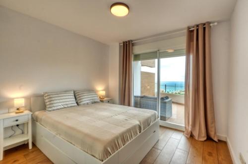 a bedroom with a bed with a view of the ocean at Isea & Sun Calaceite in Torrox Costa