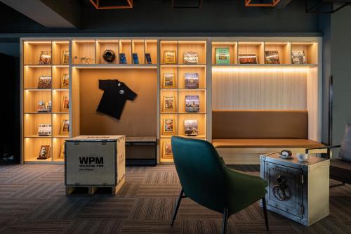 a room with a bench and a chair and a shelf at Suzhou Desti Youth Park Hostel in Suzhou