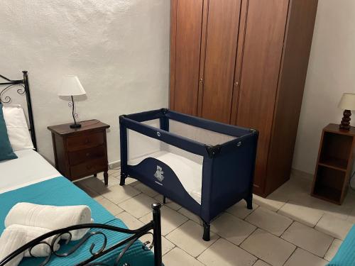 a blue crib in a bedroom with a bed at La Meridiana Antica Residenza in Mesagne