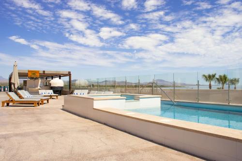 a swimming pool on the roof of a building at Aventuras Hotel in Loreto