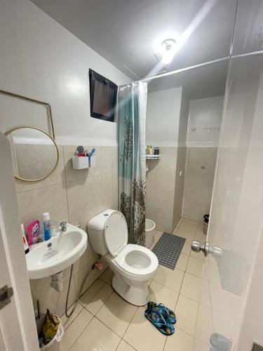 a bathroom with a toilet and a sink and a shower at Royal Oceancrest Mactan - Resort type Condominium Unit 0215B in Sudtungan