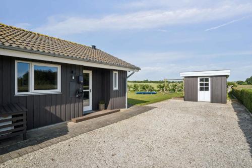 a small house with a gravel driveway next to it at Lovely Summer House In Haderslev in Haderslev