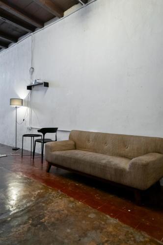 a living room with a couch and a table at Aayu Seckchuan - 3 mins walk to Love Lane in George Town