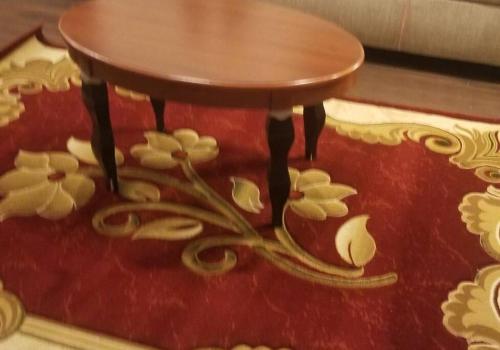 a small wooden table on a red rug with flowers at Beautiful New 4 Bedroom 3 Bath Family Home Or 1 BR Apt Nr Howard U Downtown NW DC in Washington, D.C.