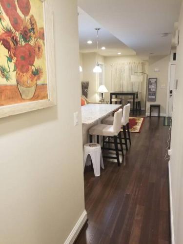 a kitchen and dining room with a table and chairs at Beautiful New 4 Bedroom 3 Bath Family Home Or 1 BR Apt Nr Howard U Downtown NW DC in Washington, D.C.