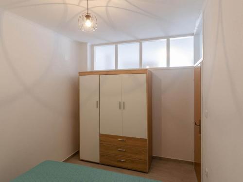 a bedroom with a cabinet and a window at Apartments K & N - One bedroom apartment A2 in Prizba