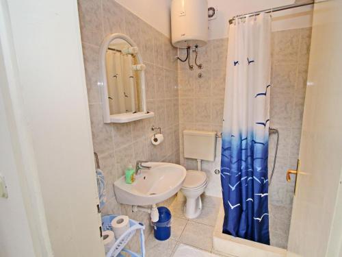 a bathroom with a sink and a toilet and a shower at Green Garden House - Four Bedroom House with Private Pool in Žrnovo