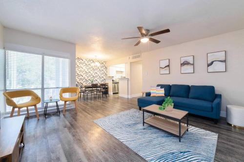 a living room with a blue couch and a table at Walk to ATT-Free Parking-Min to attractions-Modern in Arlington