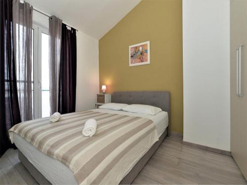 a bedroom with a bed with white towels on it at Apartments Helena - One bedroom apartment with Balcony and Sea View - A1 in Murter