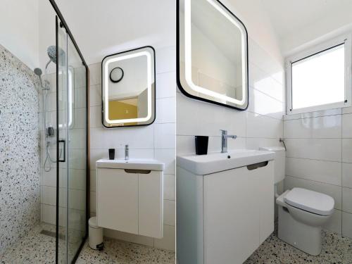 a bathroom with a sink and a toilet and a mirror at Apartments Helena - One bedroom apartment with Balcony and Sea View - A1 in Murter