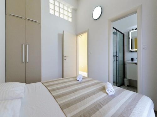 a bedroom with a large bed with towels on it at Apartments Helena - One bedroom apartment with Balcony and Sea View - A1 in Murter