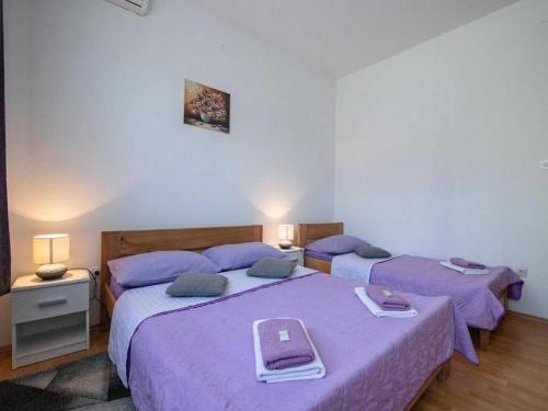 Ένα ή περισσότερα κρεβάτια σε δωμάτιο στο Apartments & Rooms Renduli - Two bedroom Suite with shared Terrace