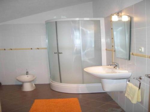 a bathroom with a shower and a sink and a toilet at Apartment in Bol with balcony in Bol