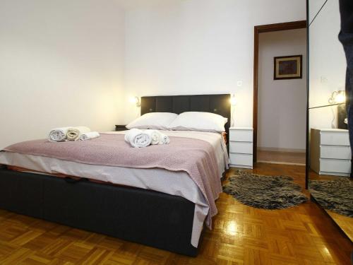 a bedroom with a large bed with towels on it at Apartment Marita - One Bedroom Apartment with Balcony in Čilipi