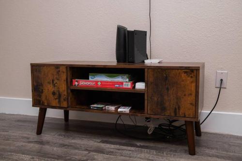 a wooden cabinet with a tv on top of it at Walk to ATT-Free Parking-Min to attractions-Modern in Arlington