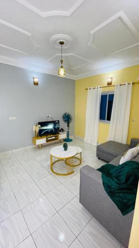 a living room with a couch and a table at NT Dreamhouse in Zalom