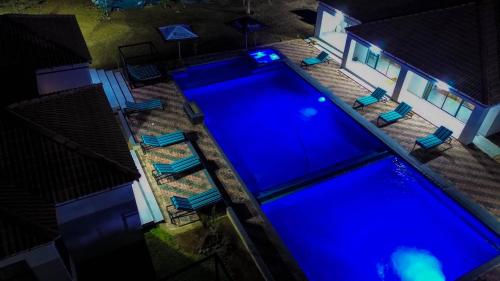 an overhead view of a large swimming pool with chairs at Mercy Boutique Hotel in Thohoyandou