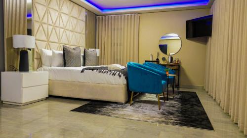a bedroom with a large bed and a mirror at Mercy Boutique Hotel in Thohoyandou