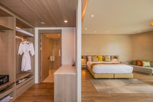 a bedroom with a bed and a living room at Aviyana Hua Hin in Cha Am