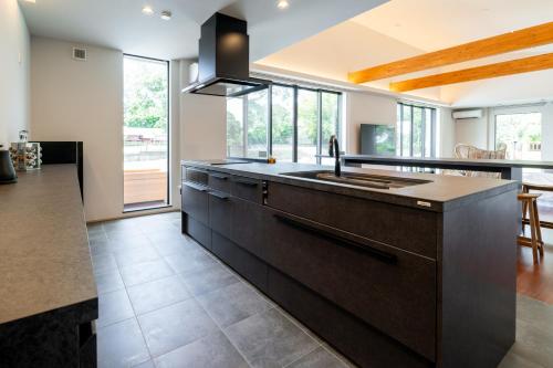 a kitchen with a sink and a counter top at EKVOLI MARINA VILLA,Isumi Garden in Chōjamachi