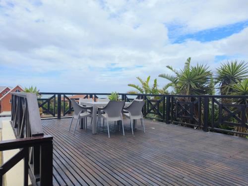 a patio with a table and chairs on a deck at Boitumelo Bluewater Apartments in Port Elizabeth