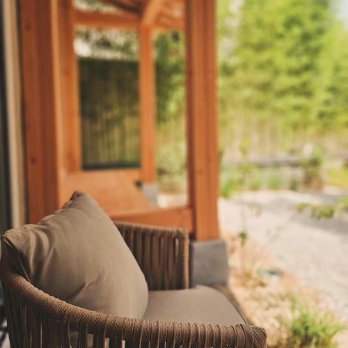 a chair with a pillow in front of a porch at Hanok Hotel DAAM Seoul in Seoul