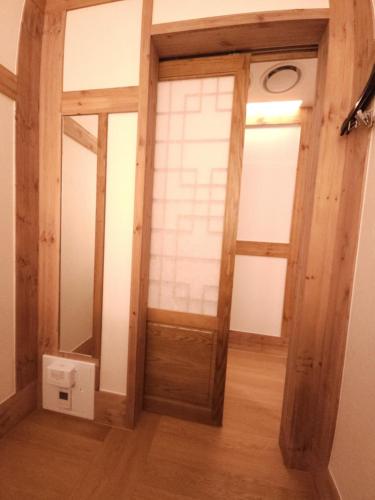 a room with a wooden door and a window at Hanok Hotel DAAM Seoul in Seoul