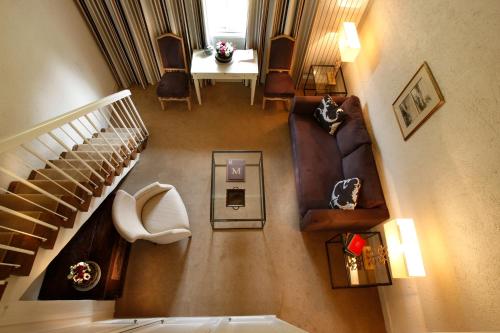 an overhead view of a living room with a staircase at Les Manoirs de Tourgéville in Deauville