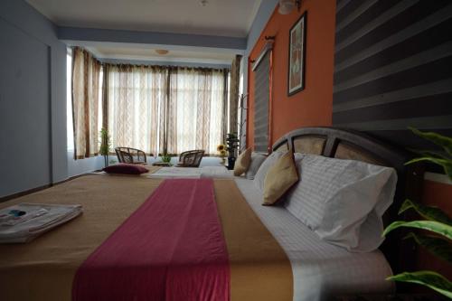 a bedroom with a large bed in a room at Vaga Hills Resort by Red Rabbit in Vagamon