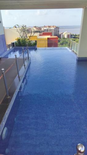 a large swimming pool on the roof of a building at Good Stay Pool view Premium Studio Apartment 206 in Dabolim