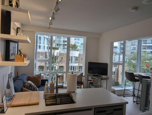 a living room with large windows and a couch at Executive Studio in Vancouver