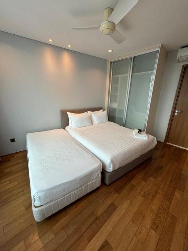 two beds sitting next to each other in a room at Stella Maison KLCC in Kuala Lumpur